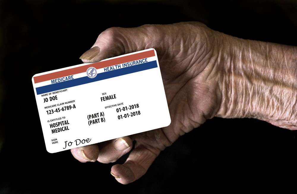Radiology patient holding a health insurance card