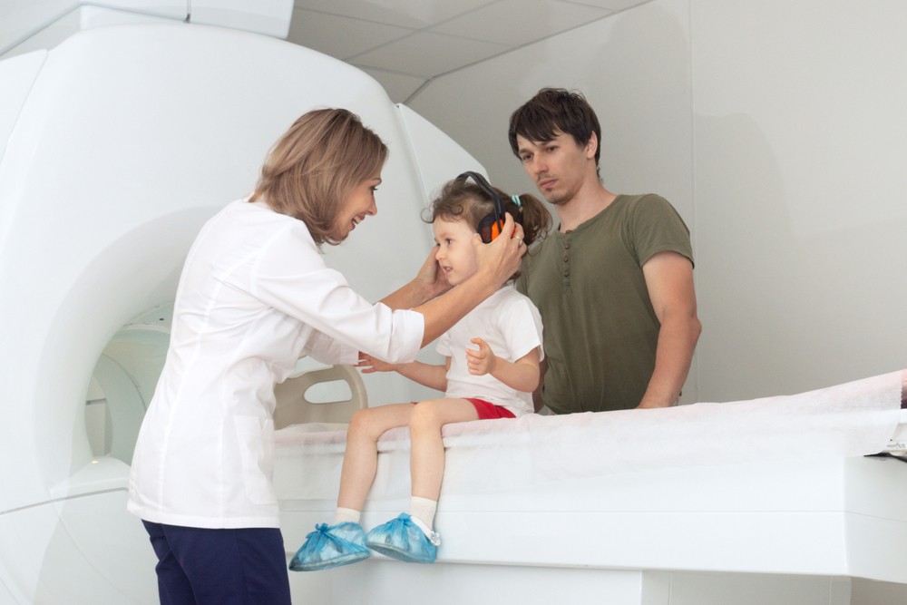 a female kid getting an MRI - pediatric radiologists is on the rise